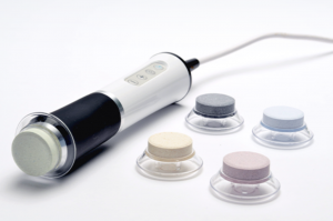 OxyGeneo facial device with multiple exfoliating treatment caps used for skin oxygenation exfoliation and nourishment